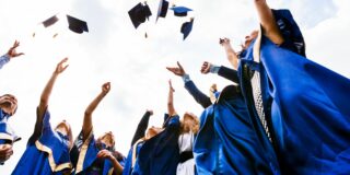 15814393 - image of happy young graduates throwing hats in the air